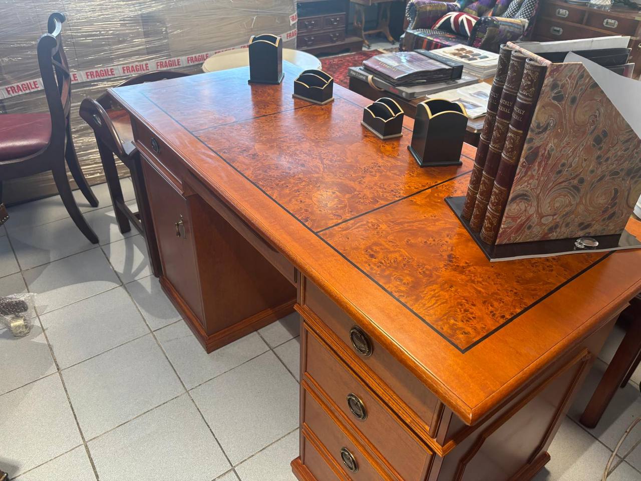 Wooden desk with books and objects in an office setting